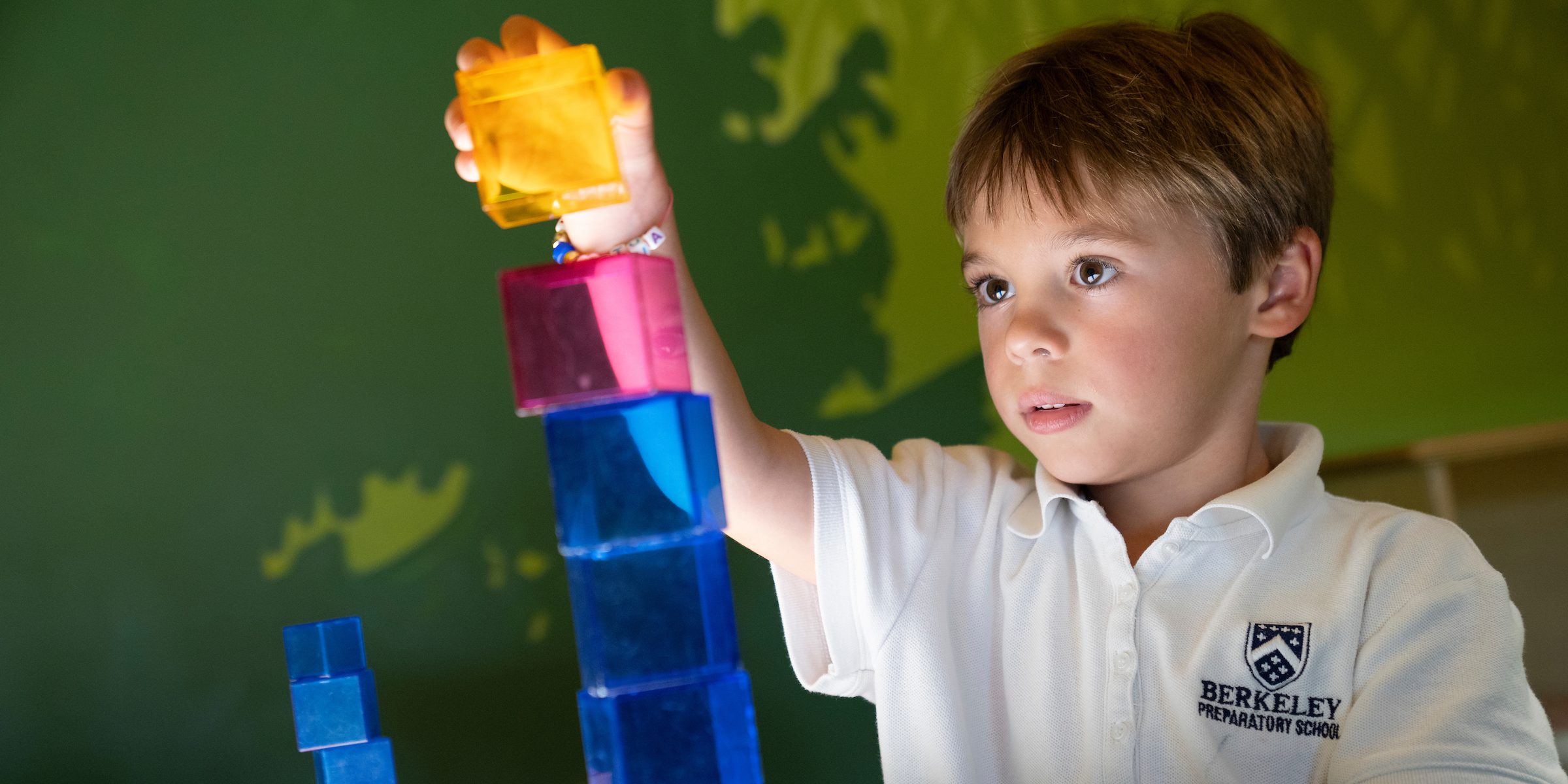 Boy playing with blocks on light table