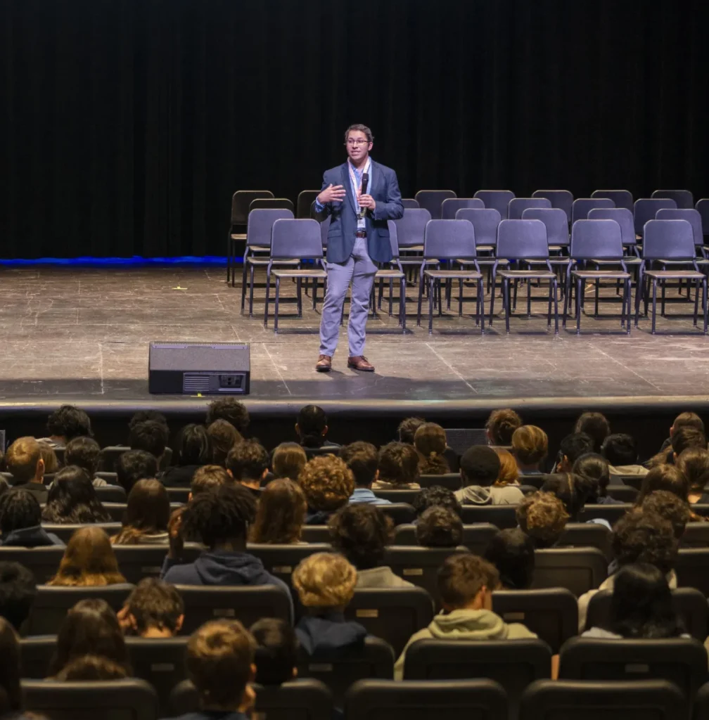 Photo of Sam Bobo speaking to Middle Division students