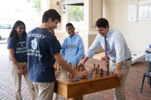Gus Whyte Playing Chess with Students