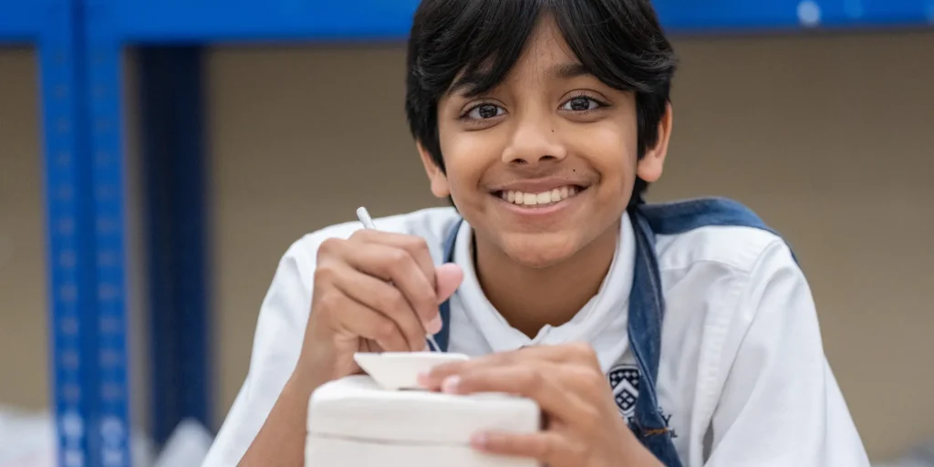 Middle division student in ceramics class banner