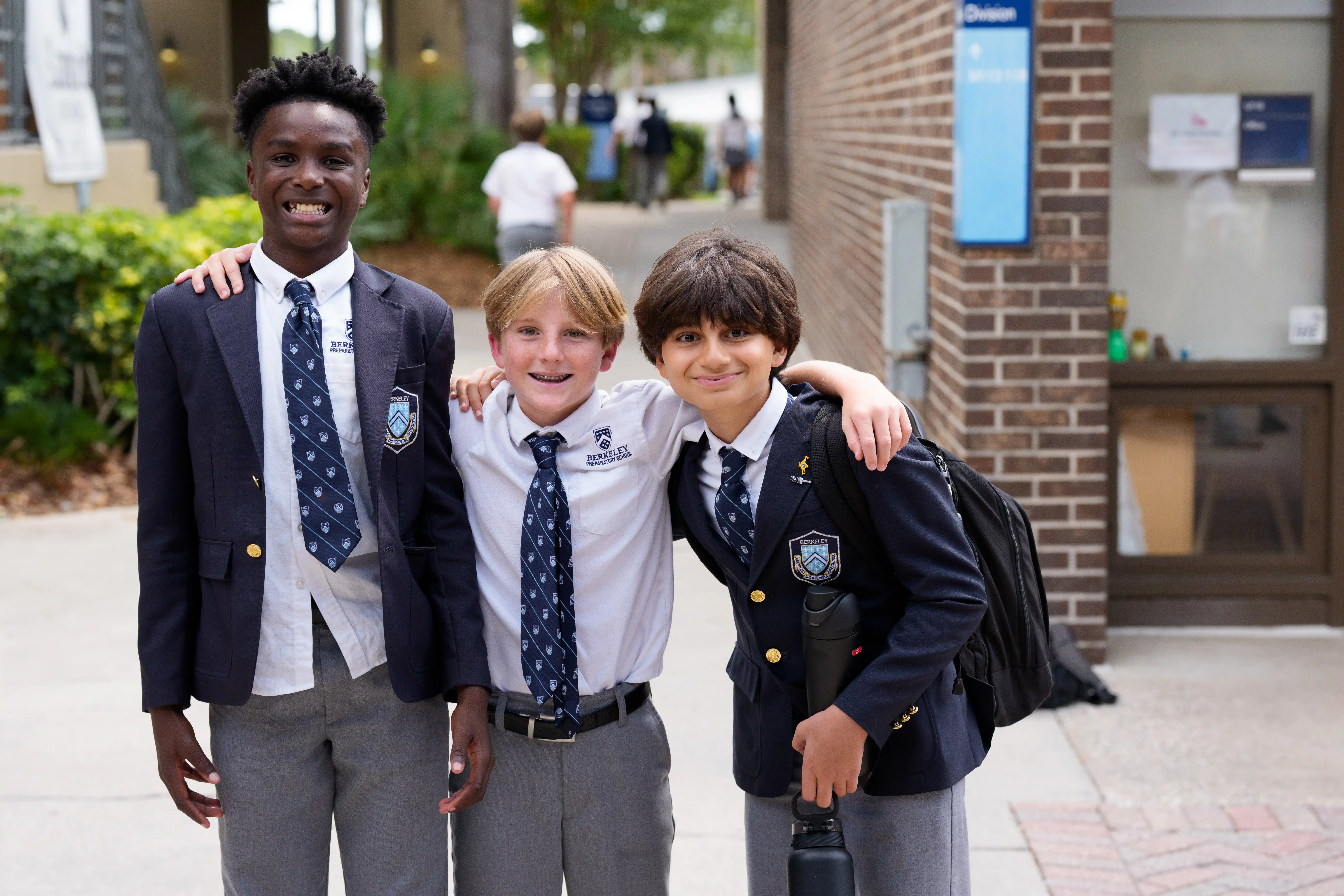 Photo of three middle school boys smiling