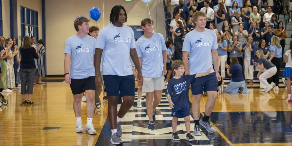 Seniors leading a Kindergarten Student